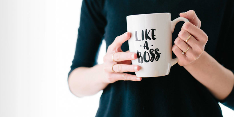 Photograph of a person's hands holding a mug that says Like a Boss
