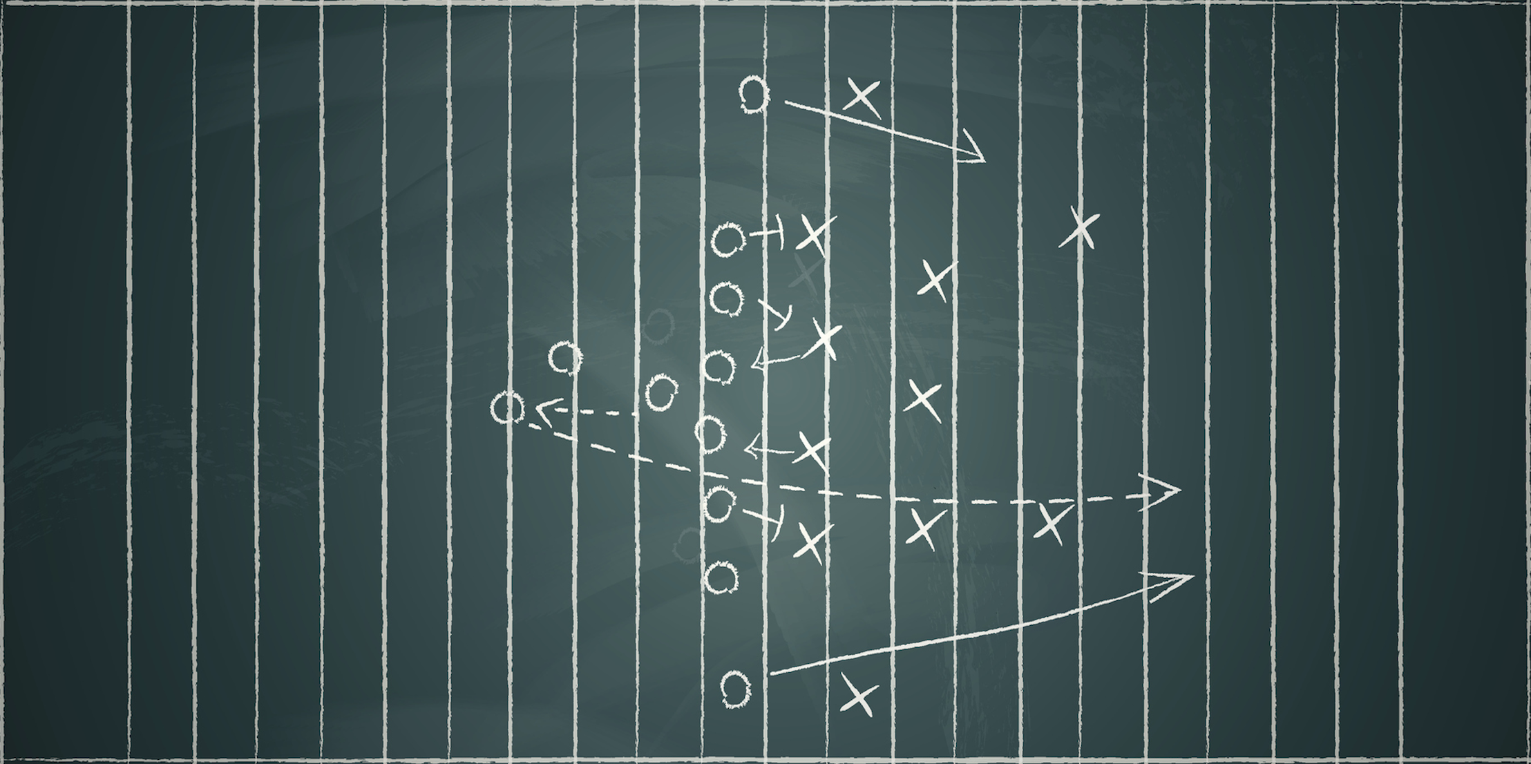 Photograph of football play drawing with X and O and arrows