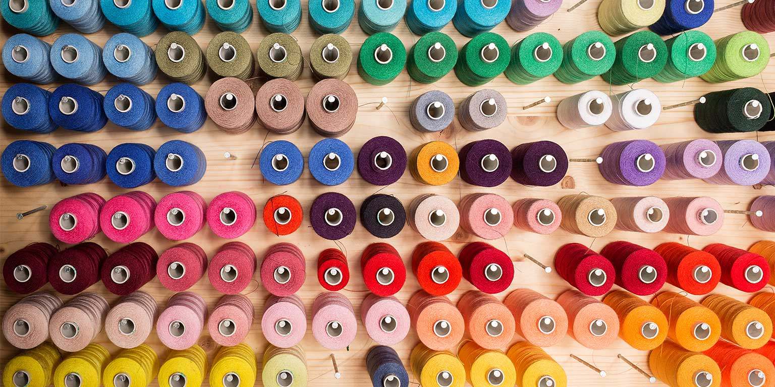Photograph of multiple spools of colorful thread
