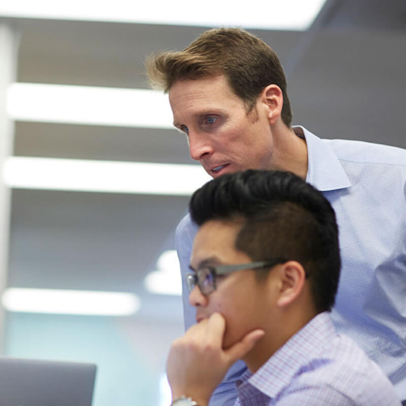 Photograph of Clari CEO Andy Byrne looking at a computer screen