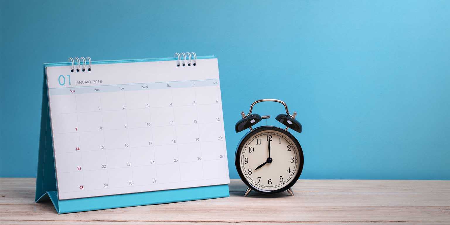 Photograph of a calendar and alarm clock on a desk