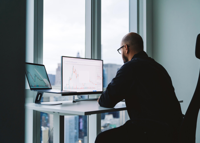 Photograph of a revenue leader looking at a Clari forecast report