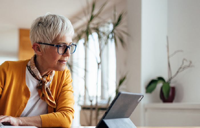 Photograph of a financial services relationship manager looking at a report on a tablet