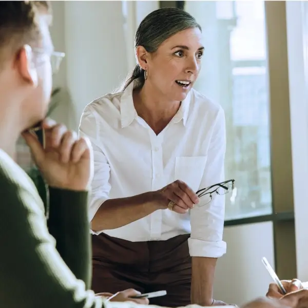 Photograph of a sales leader presenting during a team meeting